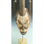 African carved wood tribal mask on stand, Ibo, Nigeria, H59cm
