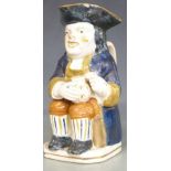 A 19thC Prattware Toby jug with foaming quart