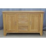 Contemporary light oak sideboard with three drawers flanked by cupboards, W150 x D48 x H85cm