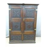 An 18th/19thC peg jointed carved oak cupboard/wardrobe, W123 x D50 x H182cm  DAVE SCARRETT-SMITH
