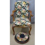 A floral upholstered mahogany armchair and footstool
