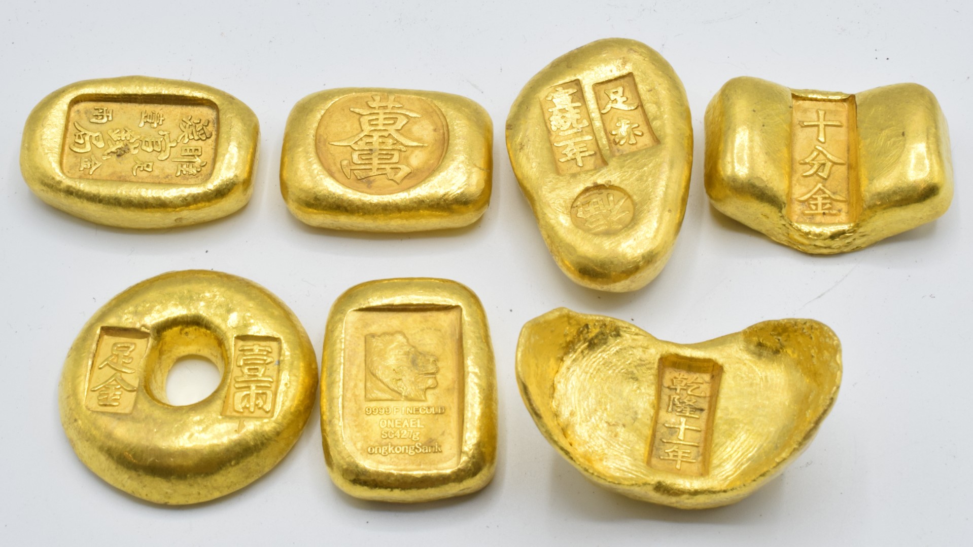 Seven Chinese gold coloured metal trade tokens/ ingots