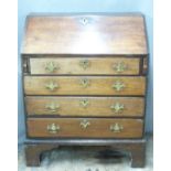 19thC oak bureau with leather inset fall flap, fitted interior and four graduated drawers, raised on