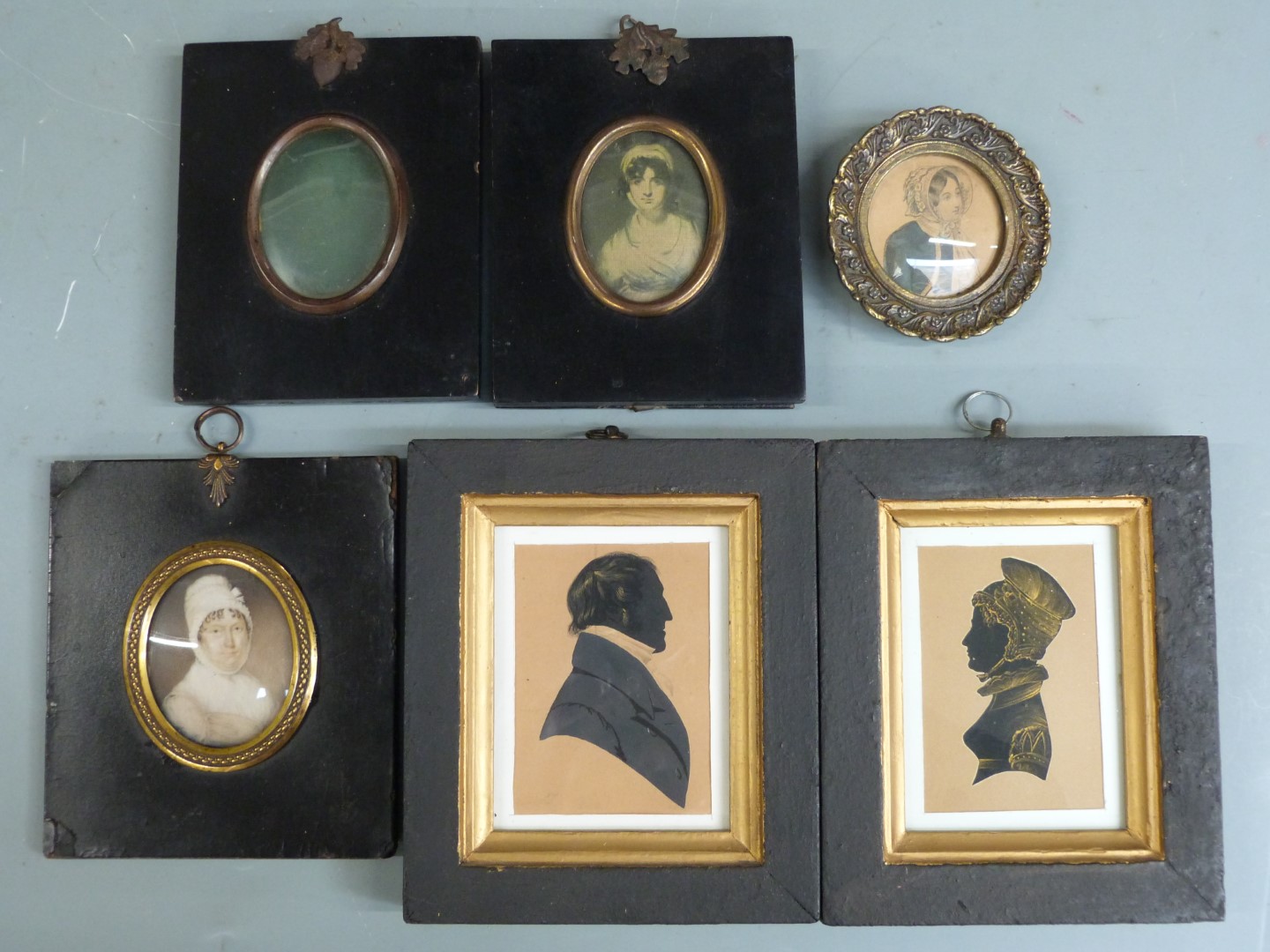 A pair of 19thC silhouettes with gold highlights in the style of Miers, portrait miniature of a lady