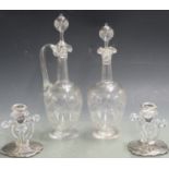 An etched glass claret jug and two matching decanters all with hollow stoppers together with a