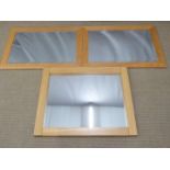 Three light oak mirrors, two with bevelled glass, largest 70 x 88cm