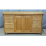 Contemporary Arts and Crafts style light oak sideboard with eight drawers flanking cupboards, W160 x