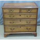 George III crossbanded oak bachelor's chest of two over three graduated drawers raised on bracket