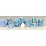 Quantity of Lamorna pottery vases, cups and a jug together with an iridescent glass vase
