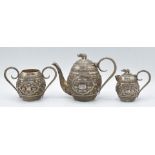 Indian or Burmese white metal bachelor's tea set with elephant finials and embossed decoration of