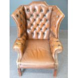 Brown leather Chesterfield wing back armchair
