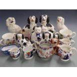 A collection of Staffordshire dogs, Gaudy Welsh and ironstone jugs, tygs etc, tallest 25cm