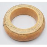 An 18th/19thC African ivory tribal bangle with dot decoration, external diameter 10cm, internal 6cm