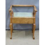 An upholstered mahogany piano stool