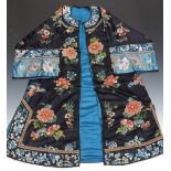 A 19thC Chinese coat with embroidered decoration and original label to the inside.