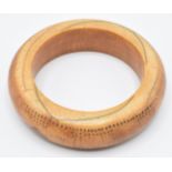 An 18th/19thC African ivory tribal bangle with geometric dot decoration, external diameter 9cm,