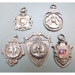 Four silver football award watch fobs together with a miniature shield, Aston Junior League,
