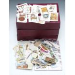 Cigarette cards in three albums together with a box of loose cards including Wills speed, Brook Bond