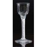 An 18thC drinking glass with air twist stem and ogee shaped bowl, 14.8cm tall.