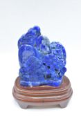 Chinese lapis lazuli carving of a mountainous scene on stand, 8.8 x 10.5cm