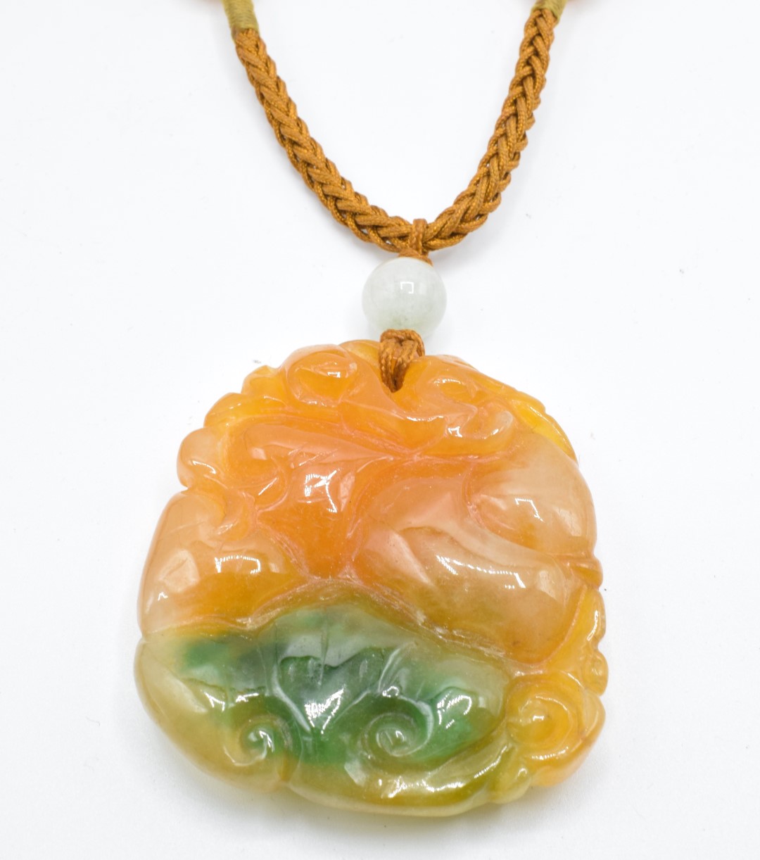 Two Chinese orange jade pendants, one depicting a creature (5.5 x 3.8cm) and the other peaches, 4. - Image 2 of 4