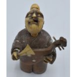 Chinese sandalwood and ivory netsuke depicting a man playing a lute with moving tongue, 7cm