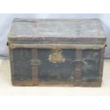 A 19thC fabric covered and lined metal bound trunk with steel drop handles and backplates, the