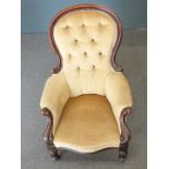 Victorian button back nursing chair with bulbous reeded legs, raised on castors