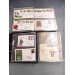 Four albums Jersey first day covers and a China 1993 stamp yearbook