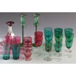 Twenty-five cranberry and green glasses and vases some with cut and flash overlaid decoration,