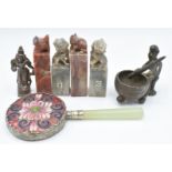 A Chinese cloisonné mirror, two pairs of Chinese soapstone seals, and a tribal bronze