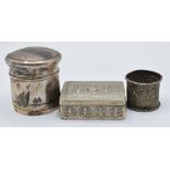 Indian or Burmese white metal napkin ring with embossed decoration of animals and palm trees,