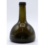 A 17th/18thC mallet shaped green glass wine bottle, 18cm tall.