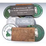 A collection of Gloucestershire Wildlife Trust cast metal, wooden and copper or similar signs and