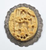A late 19thC Chinese silver brooch set with a carved ivory plaque