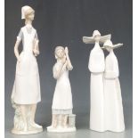 Three Lladro figures including nurses and nuns, tallest 41cm