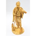 A 19thC Japanese Meiji period signed ivory okimono of a bearded man with gnarled staff and bird on