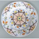 An 18thC London Delft plate decorated with a geometric polychrome design, diameter 22cm