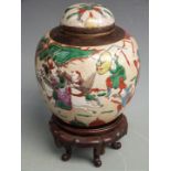A 19th/20thC Chinese crackle glazed covered ginger jar decorated with a battle scene and impressed