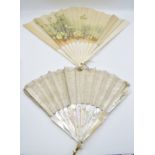 An early 20thC carved mother of pearl fan in original Selfridges, London box and a bone fan