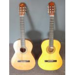 Two acoustic guitars fitted with nylon strings, one unlabelled in high gloss lacquered finish, the