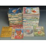 Ninety-six Rupert related books, annuals and comics including annuals from 1938 onward, Rupert