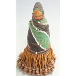 A late 19th/20thC Africian tribal beadwork figure with trailing pierced seed/treen skirt, H20cm