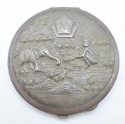 Indian white metal compact with embossed decoration depicting an elephant and man, marked sterling