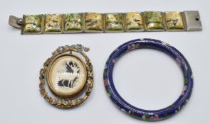 A white metal bracelet set with painted mother of pearl panels, a cloisonné bangle and a Victorian