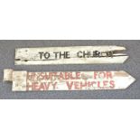 Two traditional English wooden crossroads signs 'To the church' and 'Unsuitable for heavy