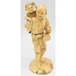 A 19thC Japanese Meiji period signed ivory okimono of a smiling man with child on his back, with