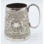 Indian white metal tankard with repoussé decoration and vacant cartouche, H8cm, 131g