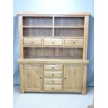 Modern oak dresser with shelves and thee drawers to top and four drawers flanked by cupboards to