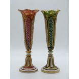 Pair of Victorian overlaid and cut glass vases with gilt decoration and white overlay over green and